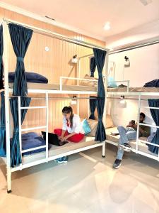 a group of people sitting on bunk beds at GreenDay Escapes Rishikesh in Rishīkesh