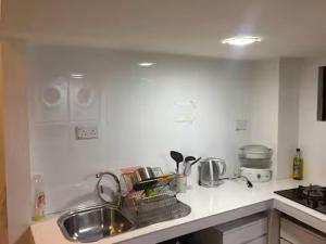 a kitchen with a sink and a counter top at Master Room at Orchard Road in Singapore