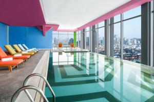 a pool in a building with a view of the city at Renaissance Shanghai Yu Garden Hotel on the Bund in Shanghai