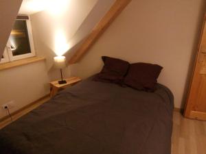 a bedroom with a bed in a attic at duplex neuf 3etoiles in Le Mont-Dore