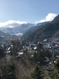 a view of a city with mountains in the background at duplex neuf 3etoiles in Le Mont-Dore