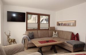 a living room with a couch and a table at Gästehaus Lipp in Mittenwald