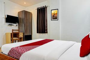 Postel nebo postele na pokoji v ubytování Hotel O Aru Sai