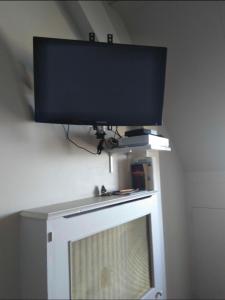 a flat screen tv sitting on top of a television at L'horizon de Trouville - Studio in Trouville-sur-Mer +6 photos