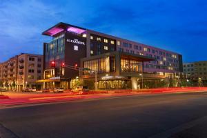 a large building on a city street at night at The Alexander in Indianapolis