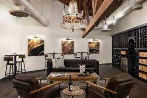 a living room with a couch and chairs and a table at Aloft Wilmington at Coastline Center in Wilmington