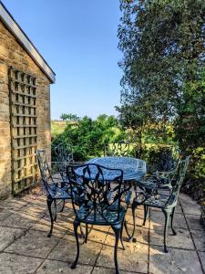 a table and chairs sitting on a patio at Keeper’s Cottage in Montacute