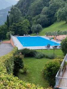 a large swimming pool in a yard with trees at Casa Bella Vista- Punta Gaeta San Siro CO in San Siro
