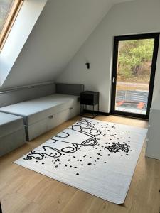 a room with a bed and a white rug at Wisełkowe Zacisze in Wisełka