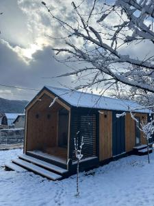 a small wooden cabin in the snow with snow covered at Роздоріжжя in Yaremche