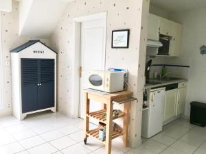 a kitchen with a counter with a microwave on it at Relax à Carnac in Carnac +4 photos