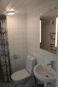 a bathroom with a toilet and a sink at Cozy cottage close to both nature and city in Lysekil
