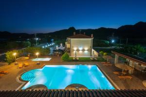 a view of a swimming pool at night at Evgatis Hotel in Kondiás