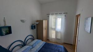 Postel nebo postele na pokoji v ubytování Punta Grande - Scala dei Turchi