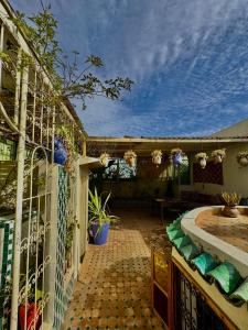 an outdoor patio with a fence and a pool at Dar Tagore in Fez
