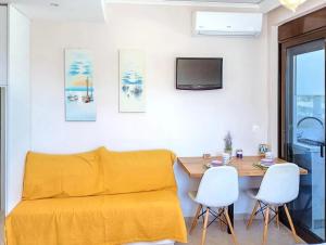 a living room with a couch and a table at 7-Modern city center studio with sea view! in Rhodes Town