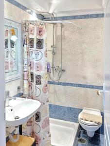 a bathroom with a sink and a toilet and a shower at 7-Modern city center studio with sea view! in Rhodes Town