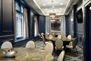 a dining room with blue walls and tables and chairs at Hotel Saint Louis, Autograph Collection in Saint Louis