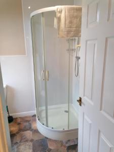a shower with a glass door in a bathroom at Edenfield Lodge in Blackpool +36 photos