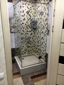 a shower with a glass door in a bathroom at Apartment for rent number 1 in Aktau