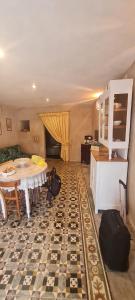 a room with a table and a kitchen with luggage at La Dimora dellaZingara in Statte +17 photos
