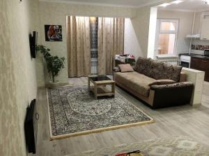 a living room with a couch and a rug at Apartment for rent number 1 in Aktau +4 photos