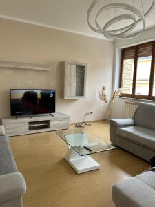 a living room with a tv and a glass coffee table at La Casa Del Matese in Piedimonte Matese