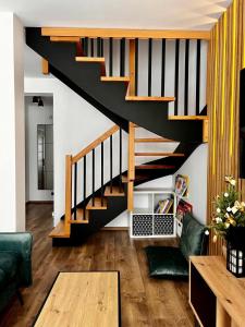 a living room with a black staircase in a house at Osiedlowa 7 in Tylicz