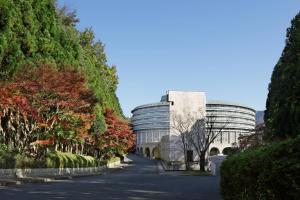 an office building with a tree lined driveway at The Prince Kyoto Takaragaike, Autograph Collection in Kyoto