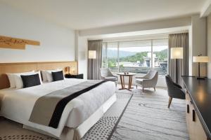 a hotel room with a large bed and a large window at The Prince Kyoto Takaragaike, Autograph Collection in Kyoto +60 photos