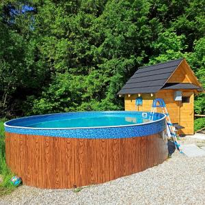 a hot tub with a house and aitating at Zawoja domki z jacuzzi, domek w stylu góralskim in Zawoja