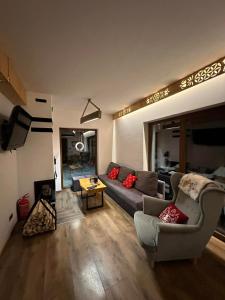 a living room with a couch and a table at Zawoja domki z jacuzzi, domek w stylu góralskim in Zawoja +29 photos