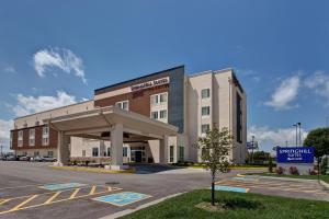 a hotel building with a parking lot in front of it at SpringHill Suites by Marriott Wichita Airport in Wichita