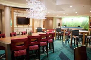 a conference room with tables and chairs and a chandelier at SpringHill Suites by Marriott Wichita Airport in Wichita