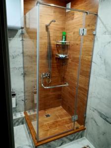 a shower with a glass door in a bathroom at Apartment for rent number 2 in Aktau