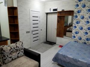 a living room with a bed and a chair at Apartment for rent number 2 in Aktau