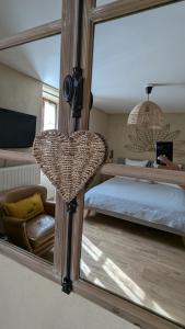 a mirror in a bedroom with a bed and a bed sqor at Aux coeurs du Méjean in Mas Saint-Chély