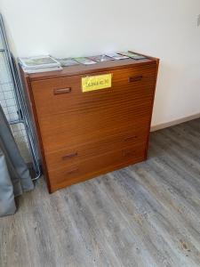 a wooden dresser with a yellow sign on it at Les Papillons Studio La Foulnerie avec cour autonome 61270 Rai proche 61300 l'Aigle -Sanateflo- in Rai-sur-Rîle