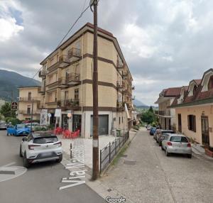 a building with cars parked in a parking lot at La Casa Del Matese in Piedimonte dʼAlife