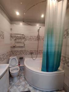 a bathroom with a tub and a toilet and a shower at Apartment for rent number 3 in Aktau