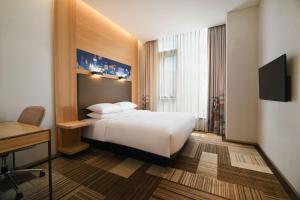 a hotel room with a bed and a desk at Aloft Seoul Myeongdong in Seoul