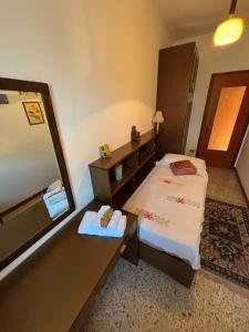a small room with a bed and a mirror at Casa Rosa in Cassina Valsassina +8 photos