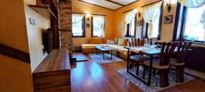 a living room with a table and a couch at Guest House Chepelare in Chepelare