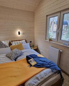 a bedroom with a large bed in a room at Tiny House Lotta - Auszeit-Oase am Plauer See in Stuer +8 photos