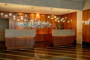 a restaurant with wooden walls and chandeliers at Renaissance São Paulo Hotel in São Paulo