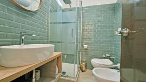 a bathroom with a sink and a toilet and a glass shower at Hosting Aparments in Rome