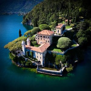 a large house on an island in the water at Campidoglio vacation home in Lenno