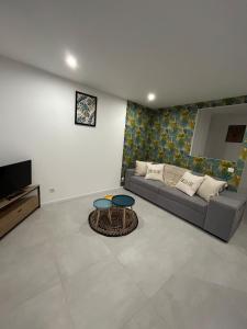 a living room with a couch and a table at Le provencal in La Roque-dʼAnthéron
