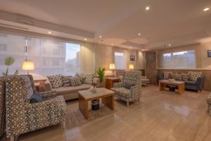 a large living room with couches and chairs at Le Beaurivage Hotel in Jeddah