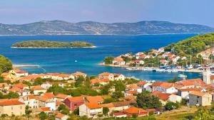 a view of a town with boats in the water at K-Rooms in Veli Iž
